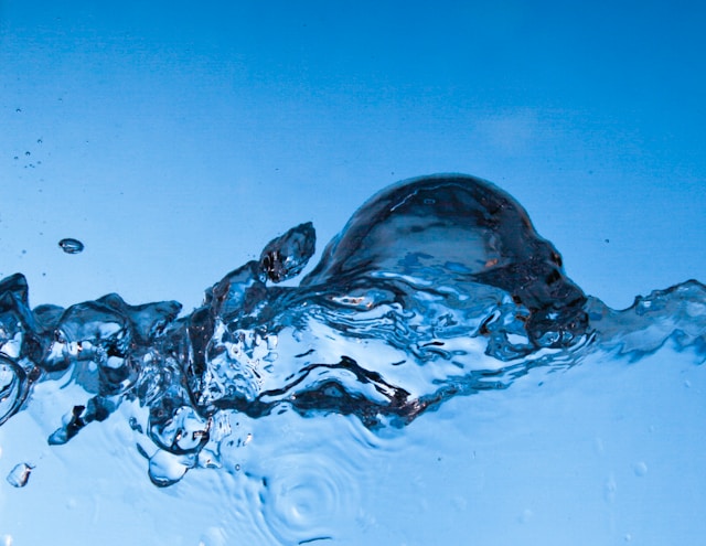 Clear water surging and splashing against a blue sky